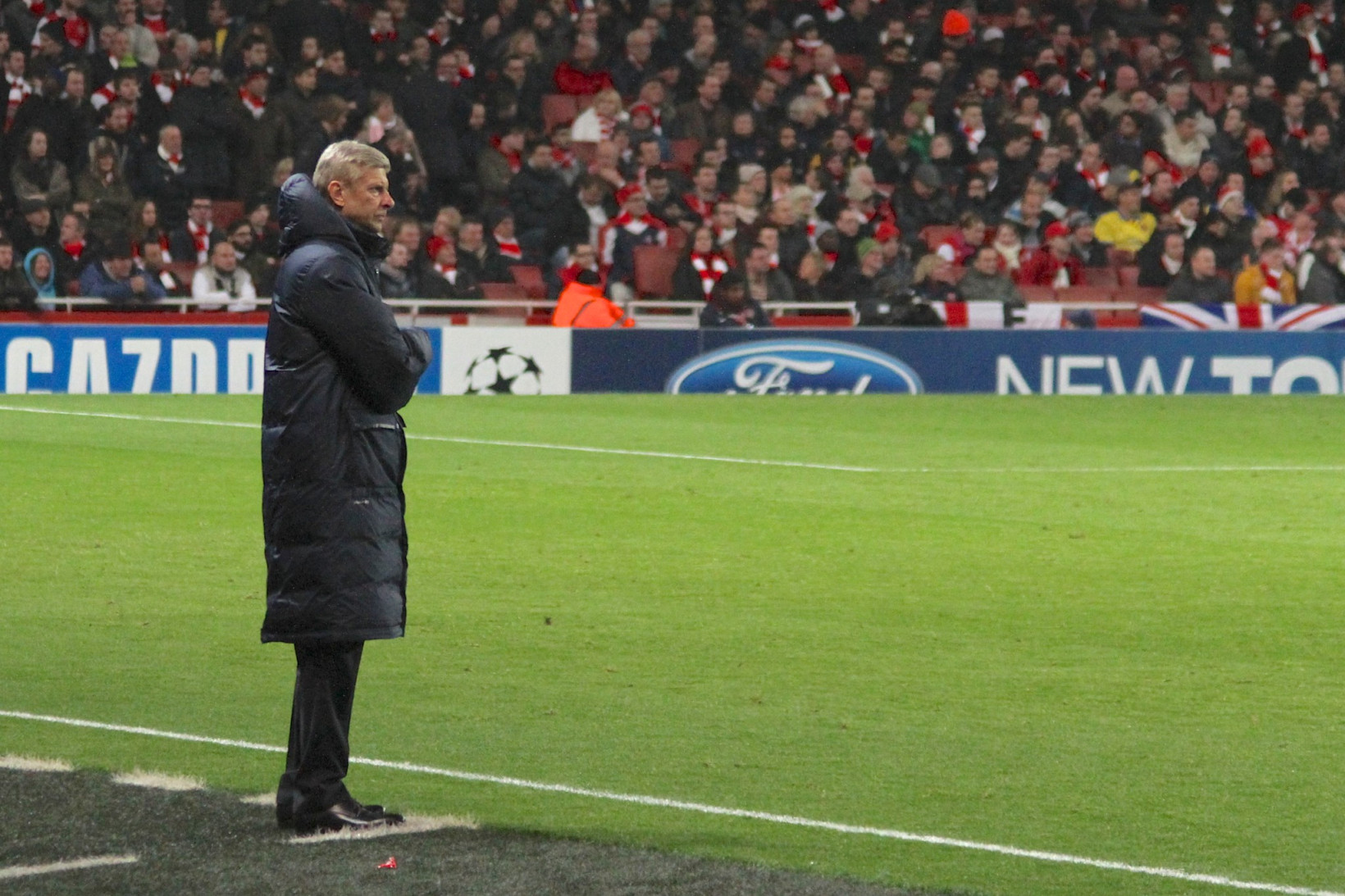 Arsene Wenger on the touchline of a football pitch