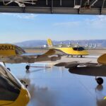 4 yellow wisk evtol in a hangar overlooking hills